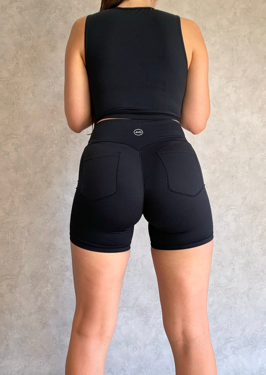 All black womens activewear gym shorts with back pockets and adjustable waistband back angle